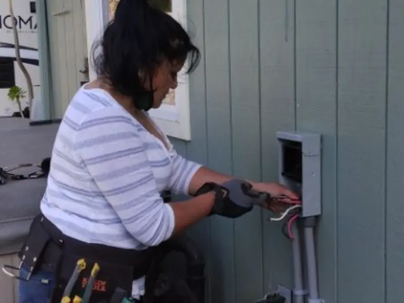 Licensed electrician wiring an exterior subpanel in Liberty